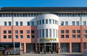 Fassade des Hotel Metropol mit Bus im Vordergrund.