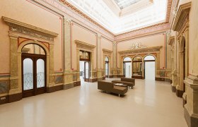 Innenansicht des Arnulf Rainer Museums mit eleganter Architektur und Sitzgelegenheiten.