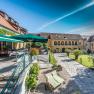 Innenhof des Althof Retz mit Terrasse, Sonnenschirmen und Gartenm&ouml;beln.