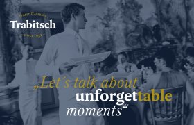 Ein Kellner serviert bei einer eleganten Veranstaltung. Text: "Let's talk about unforgettable moments". Trabitsch Catering Logo oben links.